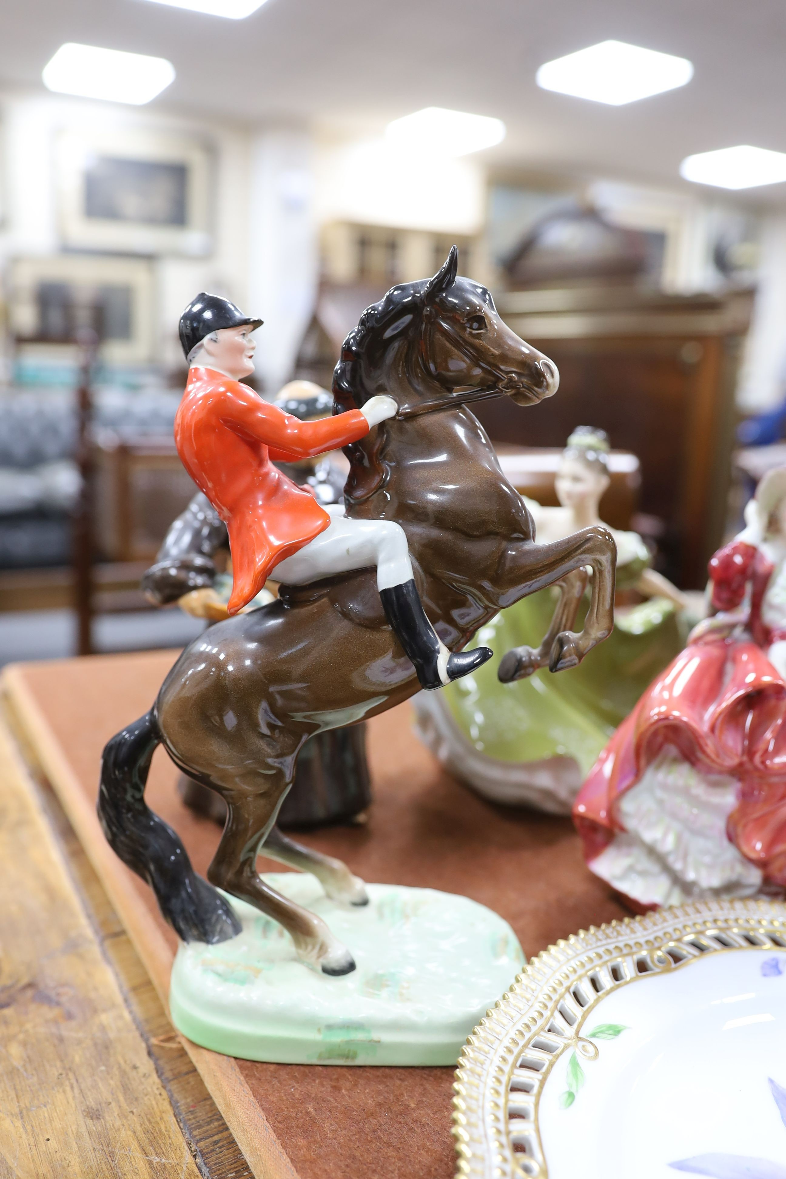 A Copenhagen porcelain botanical plate 'Prisspuria', a Beswick rearing horse huntsman and three Doulton figures (5)